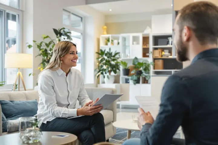 Consultant and client in a bright office discussing insurance.