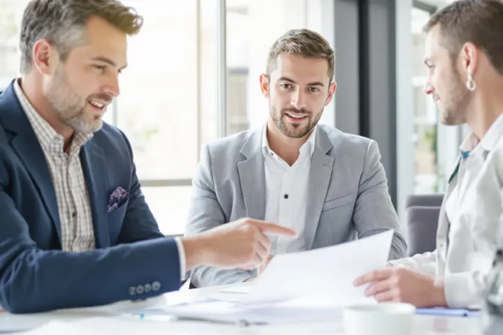 Advisor and client discussing insurance in a bright office.